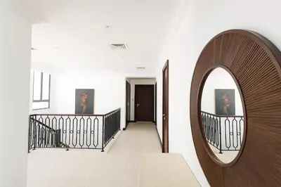 a hallway with a circular mirror on the wall at BLVD Beach House in Dubai
