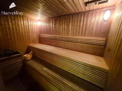 a wooden sauna with a bench in it at MarvelStay - Beach 5 mins - Fits 3 - Pool-Gym-Sauna - Marina in Dubai