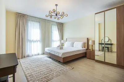 a large bedroom with a bed and a mirror at Exclusive 2BR in Rahaal 2, Madinat Jumeirah Living in Dubai