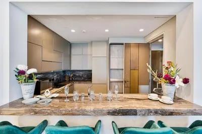 a kitchen and dining room with a table and chairs at Lavish 2-Bedroom Apartment in Dubai Oasis in Dubai