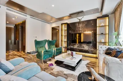 a living room with a couch and chairs and a tv at Lavish 2-Bedroom Apartment in Dubai Oasis in Dubai