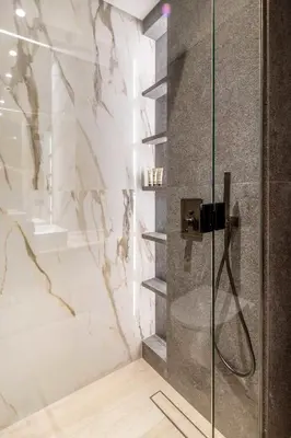 a bathroom with a shower with a glass door at Frank Porter - Grove by Eman in Dubai