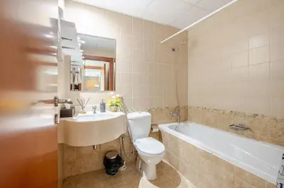 a bathroom with a toilet and a sink and a tub at Two Bedroom with Full marina view in Dubai