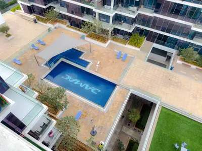an overhead view of a swimming pool in a building at Greenery Haven 2 Bed plus Study in Damac Hills in Dubai
