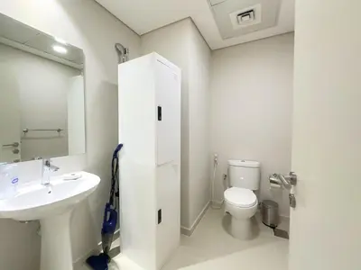 a bathroom with a sink and a toilet and a mirror at Greenery Haven 2 Bed plus Study in Damac Hills in Dubai