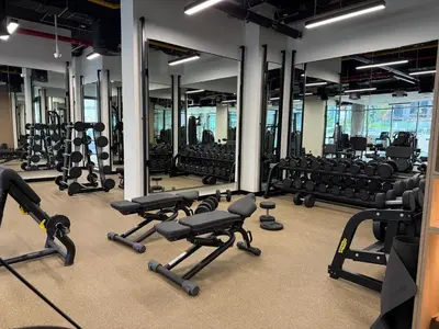 a gym with several rows of treadmills and machines at Stylish Studio with Burj Khalifa Views in Dubai