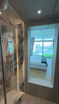 a window in a room with a view of a bed at Beachside Palm Jumeirah 1 Br apartment in Dubai