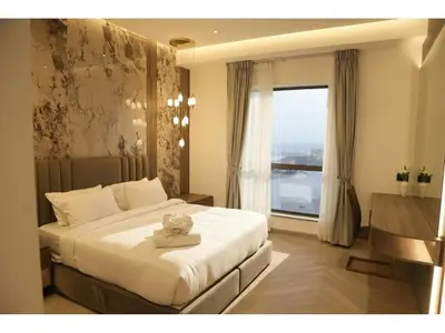 a bedroom with a large bed and a window at The bahar bloom stay in Dubai