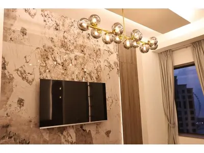 a chandelier hanging from a wall covered in dirt at The bahar bloom stay in Dubai