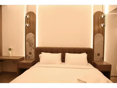 a bedroom with a large bed with white sheets at The bahar bloom stay in Dubai