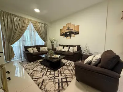 a living room with two couches and a table at Stylish & Fully Furnished 1BR in Laya Residence in Dubai