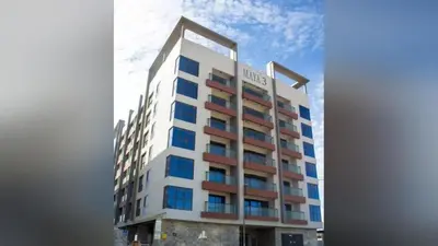 a tall building with blue windows on it at Newly Furnished 1BHK Apartment in Maya Residency in Dubai