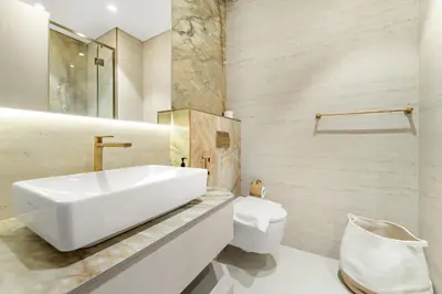 a bathroom with a white sink and a toilet at VayK - Refined 1 BD Apartment in JVC in Dubai