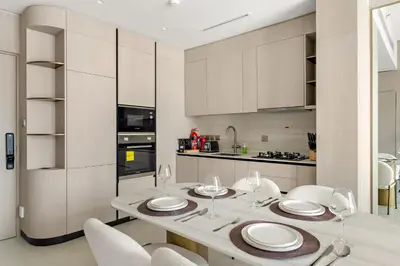 a kitchen with a white table and chairs and a table and chairsktop at VayK - Refined 1 BD Apartment in JVC in Dubai