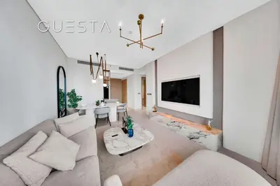 a living room with a couch and a table at Vida Residences Dubai Mall - Burj Khalifa View, Downtown Dubai in Dubai