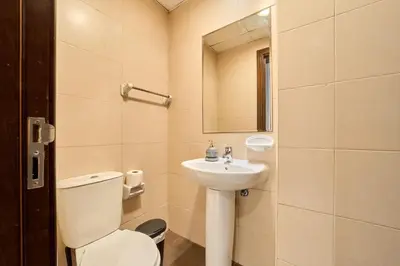 a bathroom with a toilet and a sink at Peaceful 1BR with Balcony at Elite Residence Dubai in Dubai