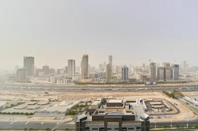 an aerial view of a city with tall buildings at Peaceful 1BR with Balcony at Elite Residence Dubai in Dubai