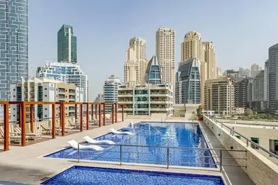 a balcony with a swimming pool on top of a building at Luxury 2BHK with Floating Bed in Dubai Marina DEC1105 in Dubai