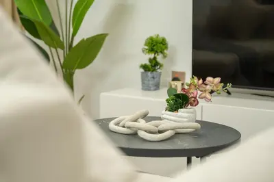 a table with two towels and plants on it at Luxury 2BHK with Floating Bed in Dubai Marina DEC1105 in Dubai
