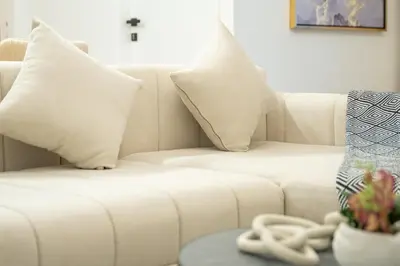 a white couch with pillows and a table at Luxury 2BHK with Floating Bed in Dubai Marina DEC1105 in Dubai
