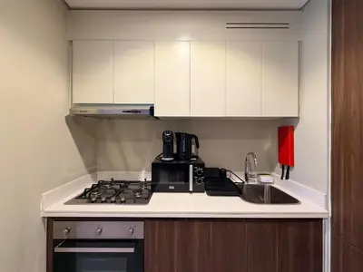 a kitchen with a sink and a stove top oven at Modern 1BR Apt - Canal View in Dubai
