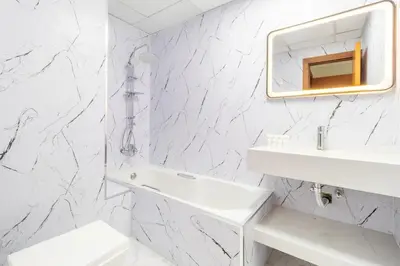 a white bathroom with a sink and a mirror at Luxury 2BR in Dubai Marina Man 1014 in Dubai