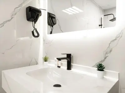 a white bathroom with a sink and a phone at Luxury 3BHK w Floating Bed in Dubai Marina Man 2501 in Dubai