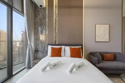 a bedroom with a large bed and a couch at Stylish Comfort Studio in Westwood Grande in Dubai