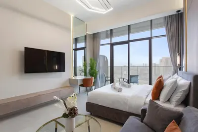 a bedroom with a bed and a tv and a couch at Stylish Comfort Studio in Westwood Grande in Dubai