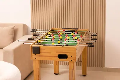 a wooden foosball table withfitsneauneauquartered at 3BHK and Floating Bed in Dubai Marina w View DEC 1707 in Dubai