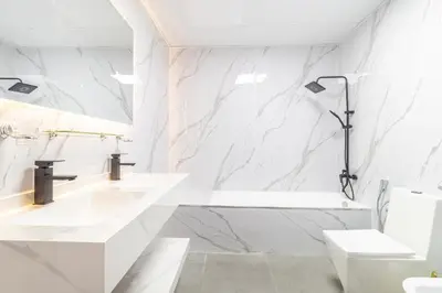 a bathroom with white marble walls and a sink and a tub at 3BHK and Floating Bed in Dubai Marina w View DEC 1707 in Dubai