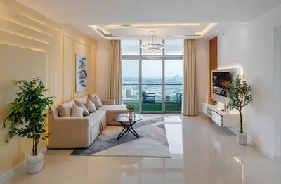 a living room with a couch and a large window at Luxury 3 BR w Floating Bed in Dubai Marina DEC 902 in Dubai