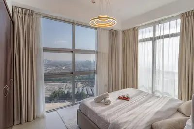 a bedroom with a bed and a large window at Luxury 3 BR w Floating Bed in Dubai Marina DEC 902 in Dubai
