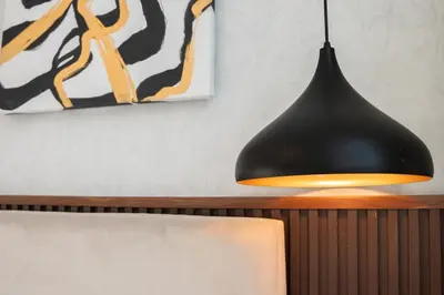 a black pendant light hanging over a table at Luxury 3 BR w Floating Bed in Dubai Marina DEC 902 in Dubai