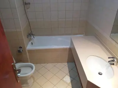 a bathroom with a tub and a toilet and a sink at Dubai Sports City home in Peaceful Location in Dubai
