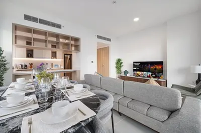a living room with a couch and a dining table at Luxury 3 Bedroom Apartment in Creek Harbour in Dubai