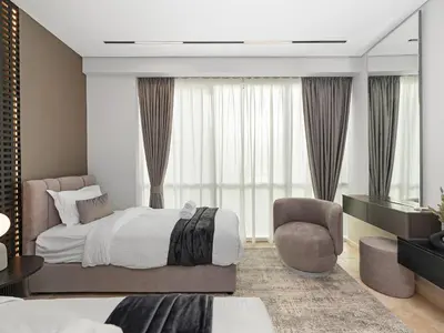 a bedroom with a bed and a chair at MegaLuxury Beachfront with Panoramic Ain Dubai Views in JBR, Sleep 12 in Dubai