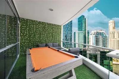 an orange pool table on a balcony with a city skyline at Luxury 5BR Marina View w Private Pool KG1004 in Dubai