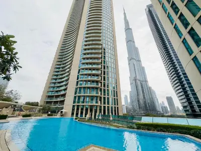 a swimming pool in front of two tall buildings at Nivis find-3BHK Apartment-Burj vista- Connected to Dubai Mall in Dubai