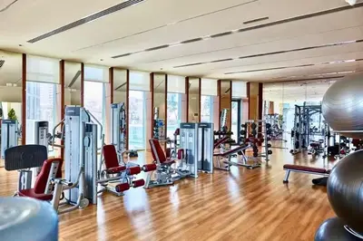 a gym with a lot of treadmills and machines at Nivis find-3BHK Apartment-Burj vista- Connected to Dubai Mall in Dubai