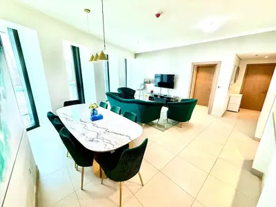 a living room with a table and some chairs at Nivis find-3BHK Apartment-Burj vista- Connected to Dubai Mall in Dubai