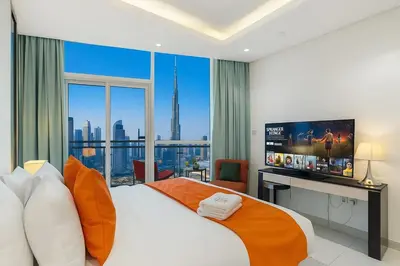 a bedroom with a large bed with a large window at Full Burj Khalifa View New Year Fireworks - DAMAC Maison Distinction in Dubai