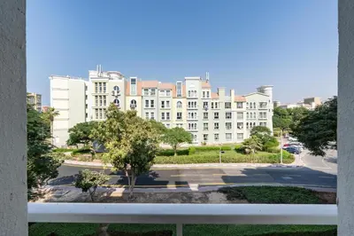 a view of a large building from a window at White Sage Discovery Gardens Renovated Studio next to Metro in Dubai