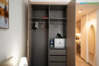 a kitchen with a walk in closet with a refrigerator at Riviera Haven Boutique Stay with Wooden Charm in Dubai