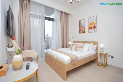 a bedroom with a bed and a large window at Riviera Haven Boutique Stay with Wooden Charm in Dubai