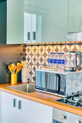 a kitchen counter with a microwave and a sink at PVH - Posh 2BR with 1 Queen Bed Plus 1 Single Bed - Collective 2-0 in Dubai