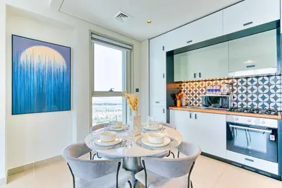 a dining room with a table and chairs and a kitchen at PVH - Posh 2BR with 1 Queen Bed Plus 1 Single Bed - Collective 2-0 in Dubai