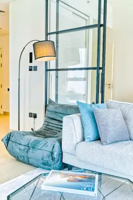 a living room with a couch and a lamp at PVH - Posh 2BR with 1 Queen Bed Plus 1 Single Bed - Collective 2-0 in Dubai