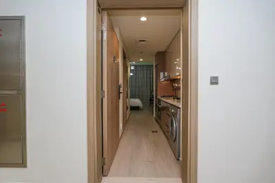 a hallway leading to the kitchen of a house at The Riviera Nook Cozy Stay in Dubai in Dubai
