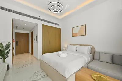 a bedroom with a large bed and a couch at Estudio Coral en Dubai By BeBalmy in Dubai